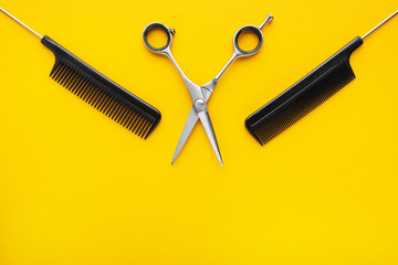 Hairdresser accessories on yellow background