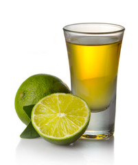 Gold tequila shot with lime isolated on white