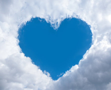 heart frame made of fluffy clouds in blue sky