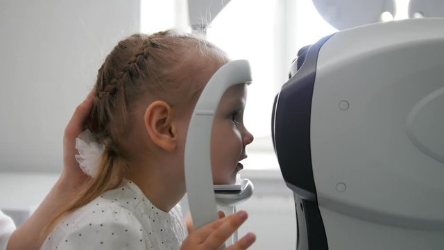 Children ophthalmology - optometrist Checks Child's Eye
