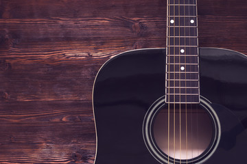 Obraz premium Acoustic guitar on wooden background