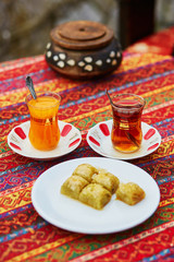 Turkish orange and black tea in traditional glasses and baklava