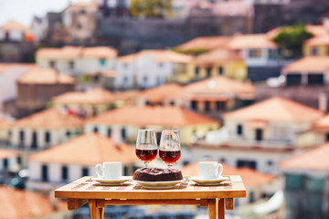 Madeira wine, coffee and bolo de mel with view to Funchal, Madeira, Portugal