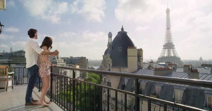 Romantic couple in Paris Eiffel Tower embrace kissing honeymoon enjoying European summer holiday travel vacation adventure