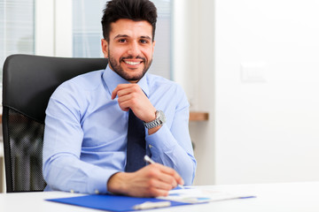Naklejka premium Businessman at work in his office