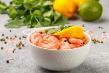  Shrimps prawns with lemon, cilantro and soy sauce in a white plate. Seafood. Selective focus