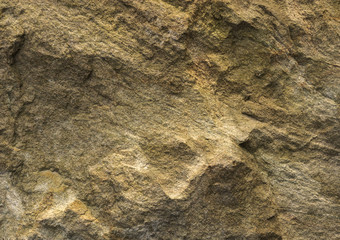 Texture of natural stone with a yellowish tinge