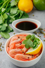  Shrimps prawns with lemon, cilantro and soy sauce in a white plate. Seafood. Selective focus