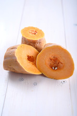 Pumpkin pieces on white table