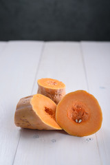 Pumpkin pieces on white table