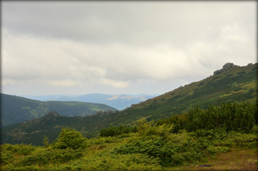 Summer landscape in mountains and the dark blue sky with clouds