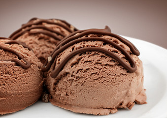 brown ice cream scoops with chocolate sauce, close-up
