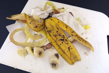 Organic garbage debris on kitchen cutting board.