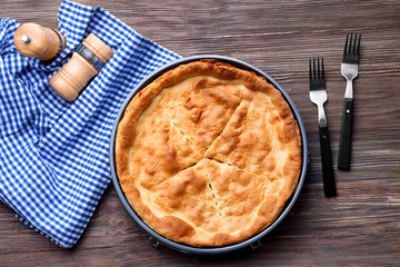 Tasty baked chicken pot pie on wooden table