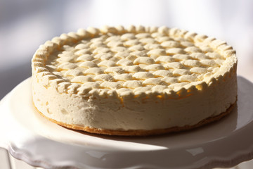 Delicious plain cheesecake on stand