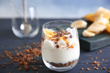 Glass of delicious dessert on wooden table