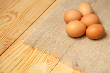 Fresh farm eggs on a wooden on wooden table