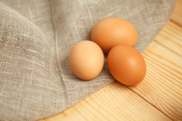 Fresh farm eggs on a wooden rustic background