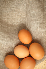 eggs on the tableChicken eggs on burlap vintage background