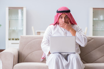 Arab businessman working sitting at couch