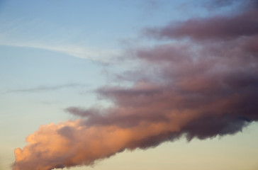 Smoky pink-gray cloud on blue sky