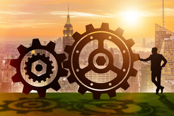 Businessman in teamwork concept with cogwheels