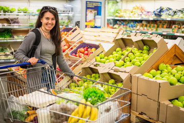 Beautiful women shopping vegetables and fruits in supermarket