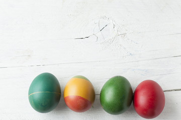 Easter eggs and white wooden country table, background and texture, copyspace