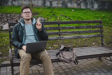Fototapeta premium young modern businessman working in park