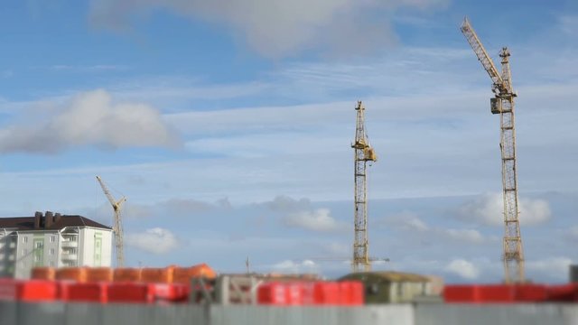 Construction cranes working on high-rise building