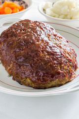 Classic American meatloaf made with ground beef oatmeal onions and a ketchup brown sugar and mustard glaze