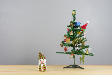 smiling snowman looking up,Vintage background with Christmas decoration on wooden desk,Merry Christmas and happy new year event concept.