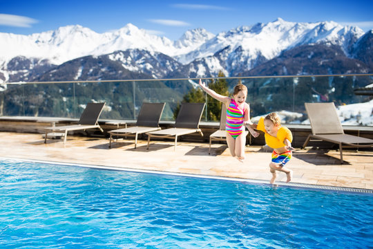 Kids in outdoor swimming pool of Alpine resort