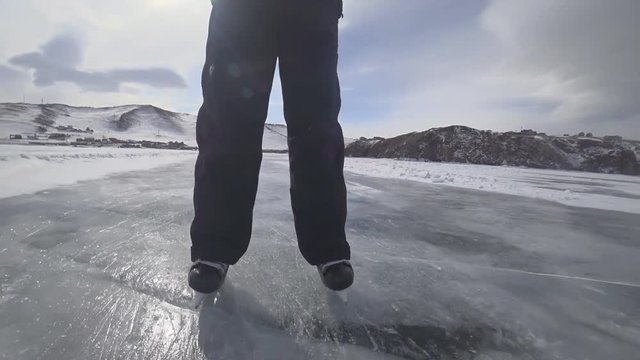 Tourists and travelers on the ice of Lake Baikal skate.