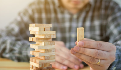 Planning, risk and strategy of project management in business, businessman and engineer gambling placing wooden block on a tower,construction with copy space,selective focus,vintage color