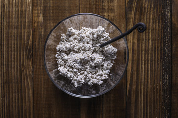 Farmers cheese mixed with cinnamon powder in glass bowl