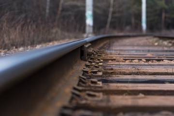The old railway track on wooden sleepers, in the woods, in the autumn,