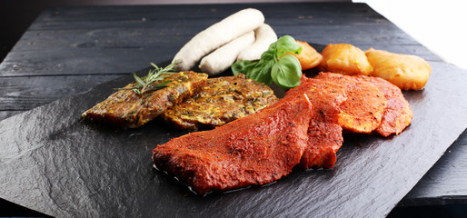 Selection of marinaded meat for grilling and sausages