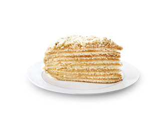 Piece of layer cake with custard and walnuts on a plate