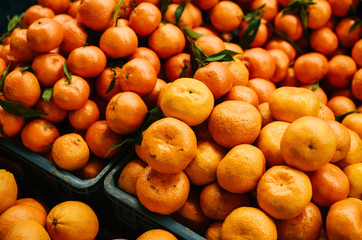 Many tangerines on the farm market on the farm market. Citrus. Products rich in vitamins. Natural local products on the farm market. Harvest. Seasonal products. Food.