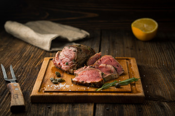 Roast beef steak with spices, seasonings and capers