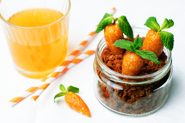 chocolate biscuit in a jar and dried apricots cashew candies in the form of carrots
