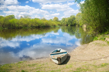 Wooden boat on the river bank