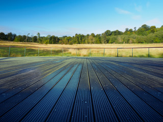 blank wooden deck against countryside landscape
