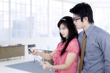 Business partners discussing with tablet