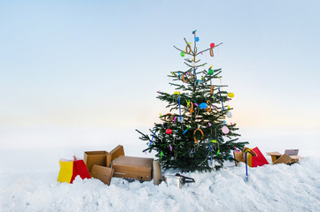 curious open air christmas tree in the snow decorated with sausages, balloons, toilet brushes and clothespins - 142848748