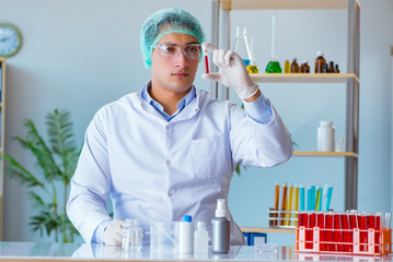 Young doctor working on blood test in lab hospital