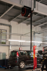 Modern automobile service station with fumes exhaust vetillation unit and elevators