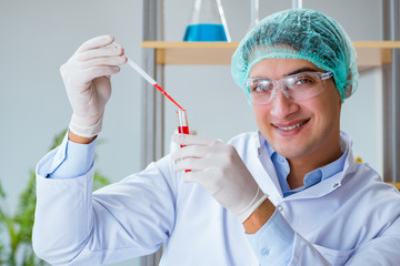 Young doctor working on blood test in lab hospital