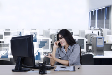 Female worker talks growth charts by phone